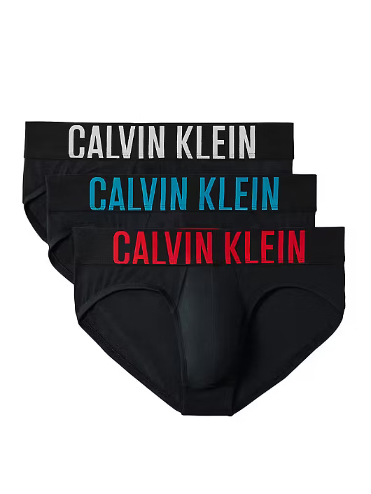 Three pairs of Calvin Klein men's briefs in black, stacked in a fan arrangement on a white background. The waistbands feature the brand name 'CALVIN KLEIN' printed in white, blue, and red respectively.