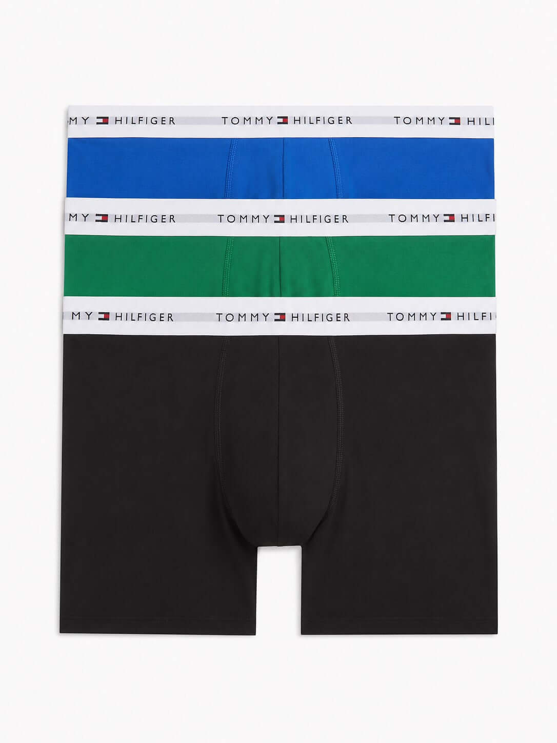 Three pairs of Tommy Hilfiger men's boxer briefs stacked vertically, featuring black, green, and blue fabrics with white waistbands printed with the brand name.
