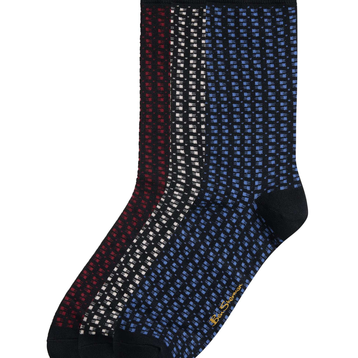 Three pairs of crew socks with a small geometric dot pattern, shown overlapping on a white background. The colors are navy blue, dark red, and black.