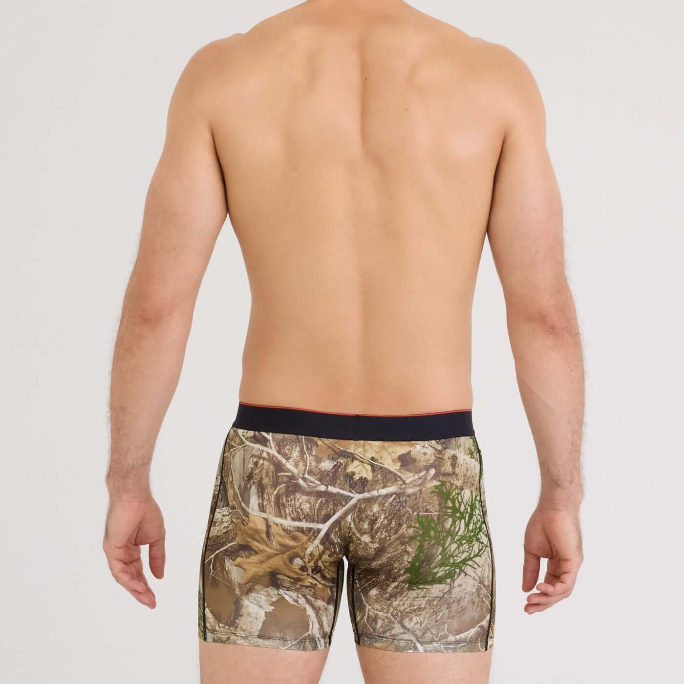 Man wearing camouflage boxer briefs on a plain background