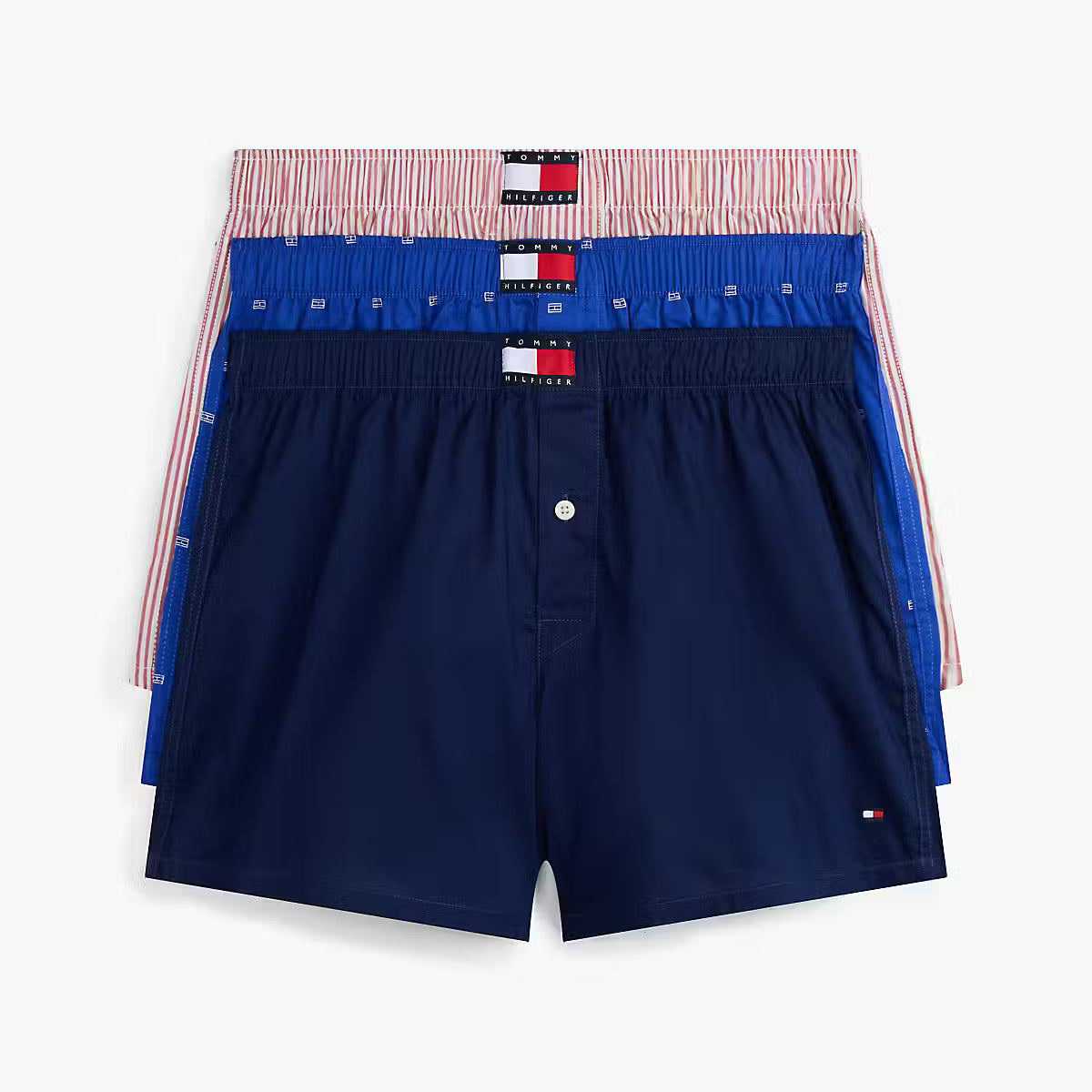Navy blue boxer shorts with a red, white, and blue waistband on a light gray background