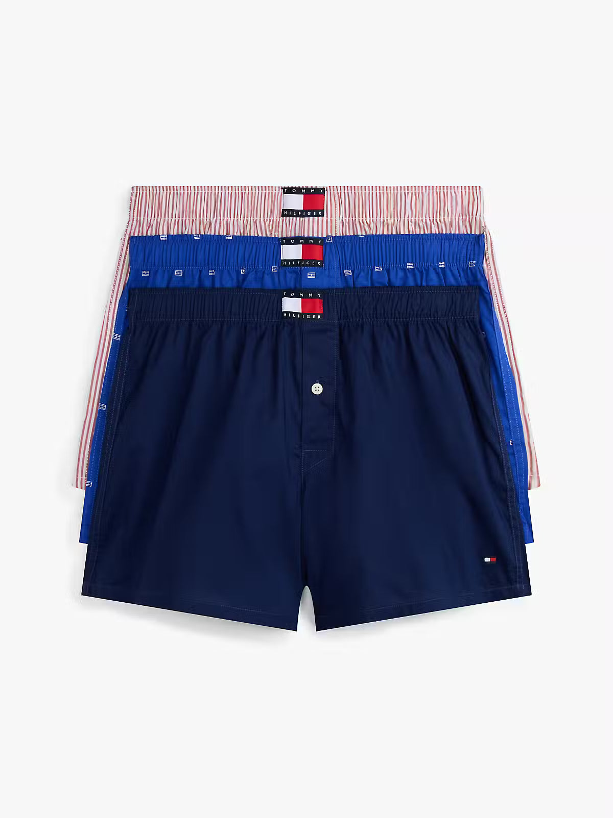 Navy blue boxer shorts with a red, white, and blue waistband on a light gray background
