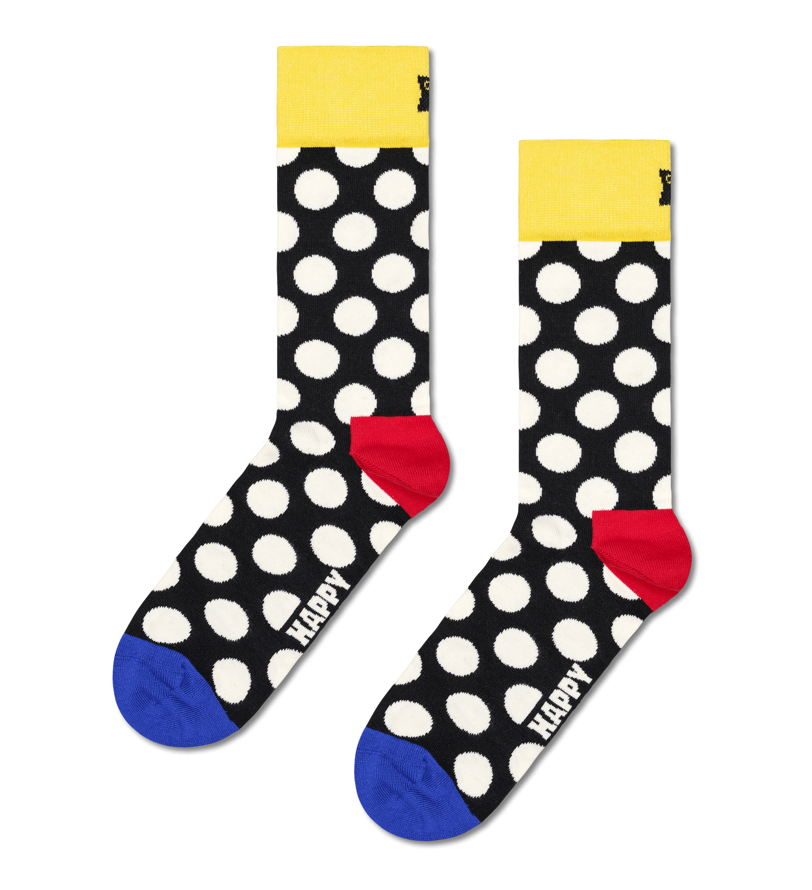 A pair of novelty crew socks with a black background, white polka dots, a bright yellow cuff, a red heel, and a blue toe. The word 'HAPPY' is printed in white on the foot.
