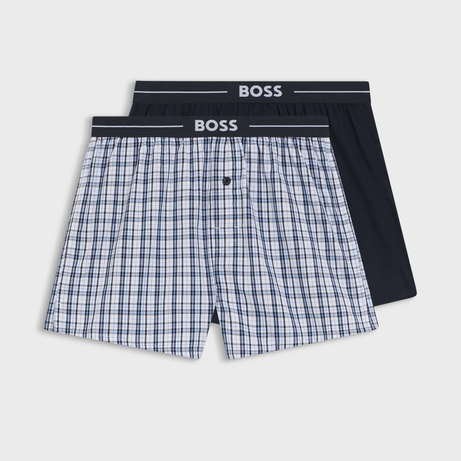 Two pairs of boxer shorts with a checkered pattern and black waistband on a white background, branded 'BOSS'.