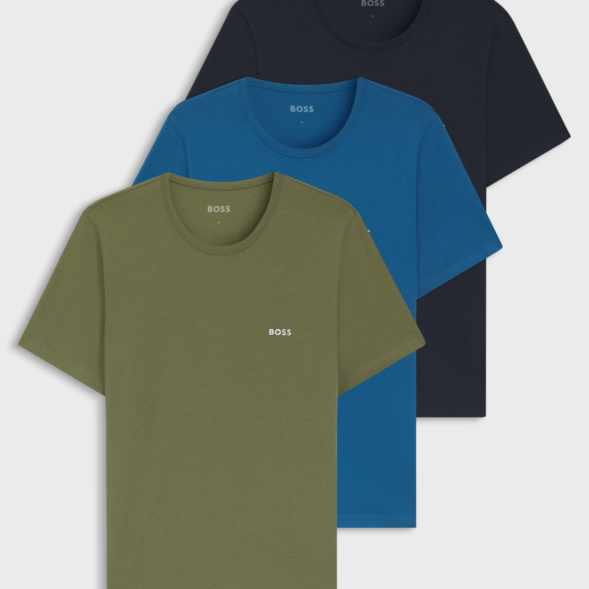 Three BOSS short-sleeve crewneck t-shirts in olive green, blue, and navy, arranged in a stacked overlapping layout on a light gray background.