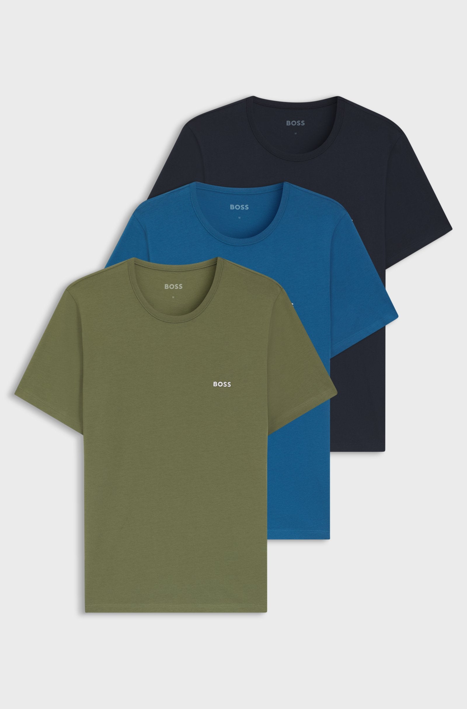 Three BOSS short-sleeve crewneck t-shirts in olive green, blue, and navy, arranged in a stacked overlapping layout on a light gray background.