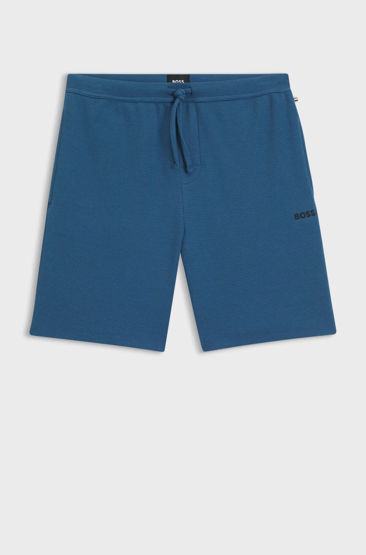 Blue shorts with a brand logo on a light gray background