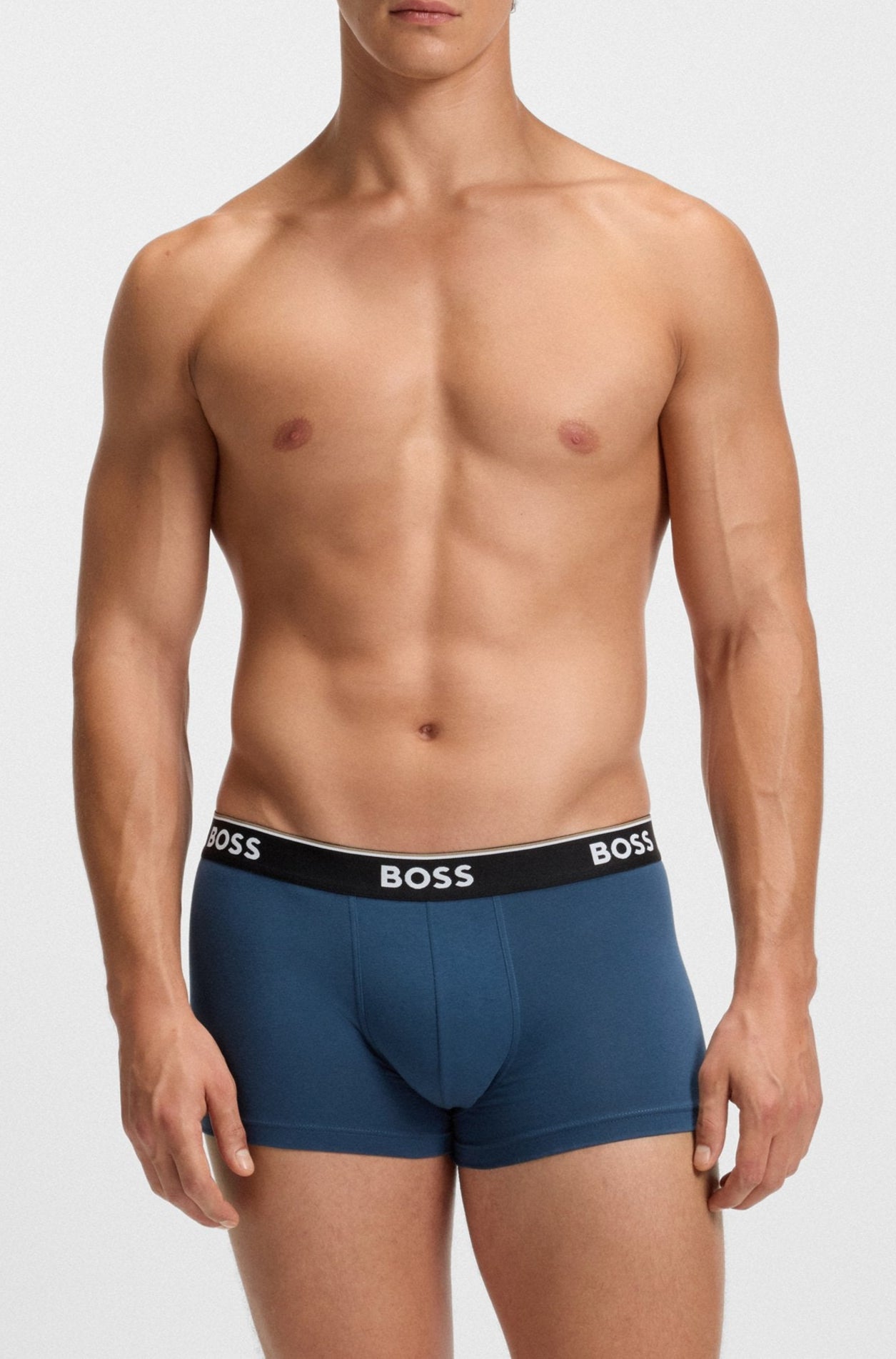 Man wearing blue BOSS underwear on a white background