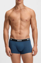 Man wearing blue BOSS underwear on a white background