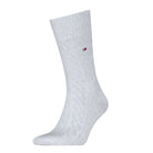Gray sock with a small red logo on a white background