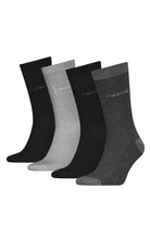 Set of four pairs of socks in black, gray, and white on a white background