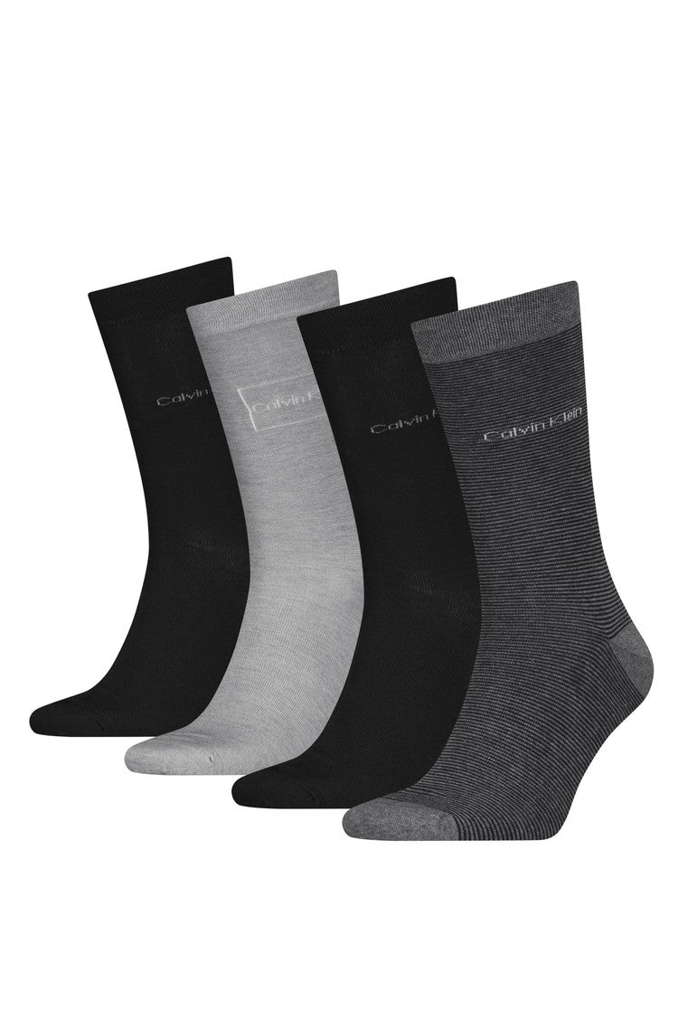 Set of four pairs of socks in black, gray, and white on a white background