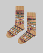 Pair of tan socks with colorful patterns on a wooden surface, featuring the brand 'Polar Star'.