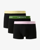 Three black Lacoste boxer briefs with colorful waistbands on a white background