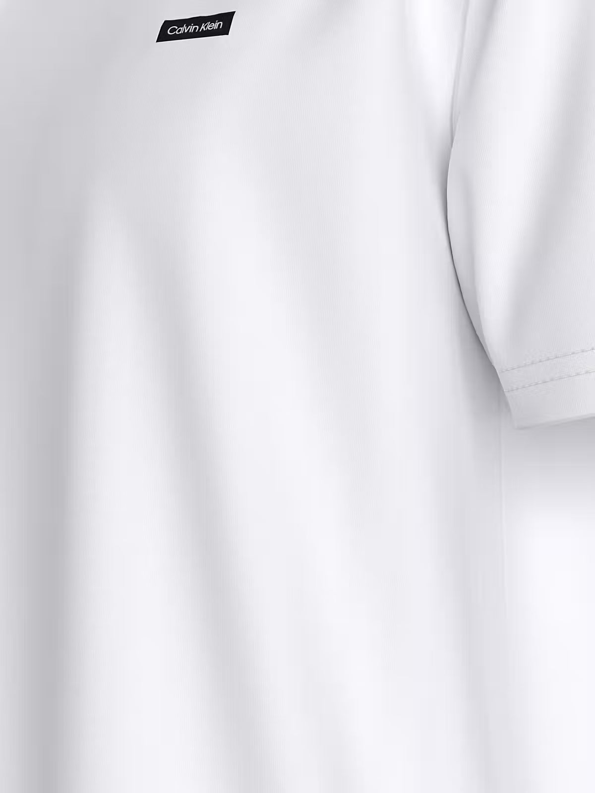 Close-up of the chest logo on a white Calvin Klein T-shirt