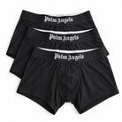Three pairs of black Palm Angels men's boxer briefs stacked diagonally on a white background, showing the white gothic logo on the elastic waistbands.