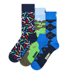 Three pairs of novelty golf socks displayed together on a white background. The left pair has a navy base with colorful golf club patterns, the middle pair features a golf course landscape with a golfer, and the right pair has a blue and navy argyle pattern with 'HAPPY GOLF' text.
