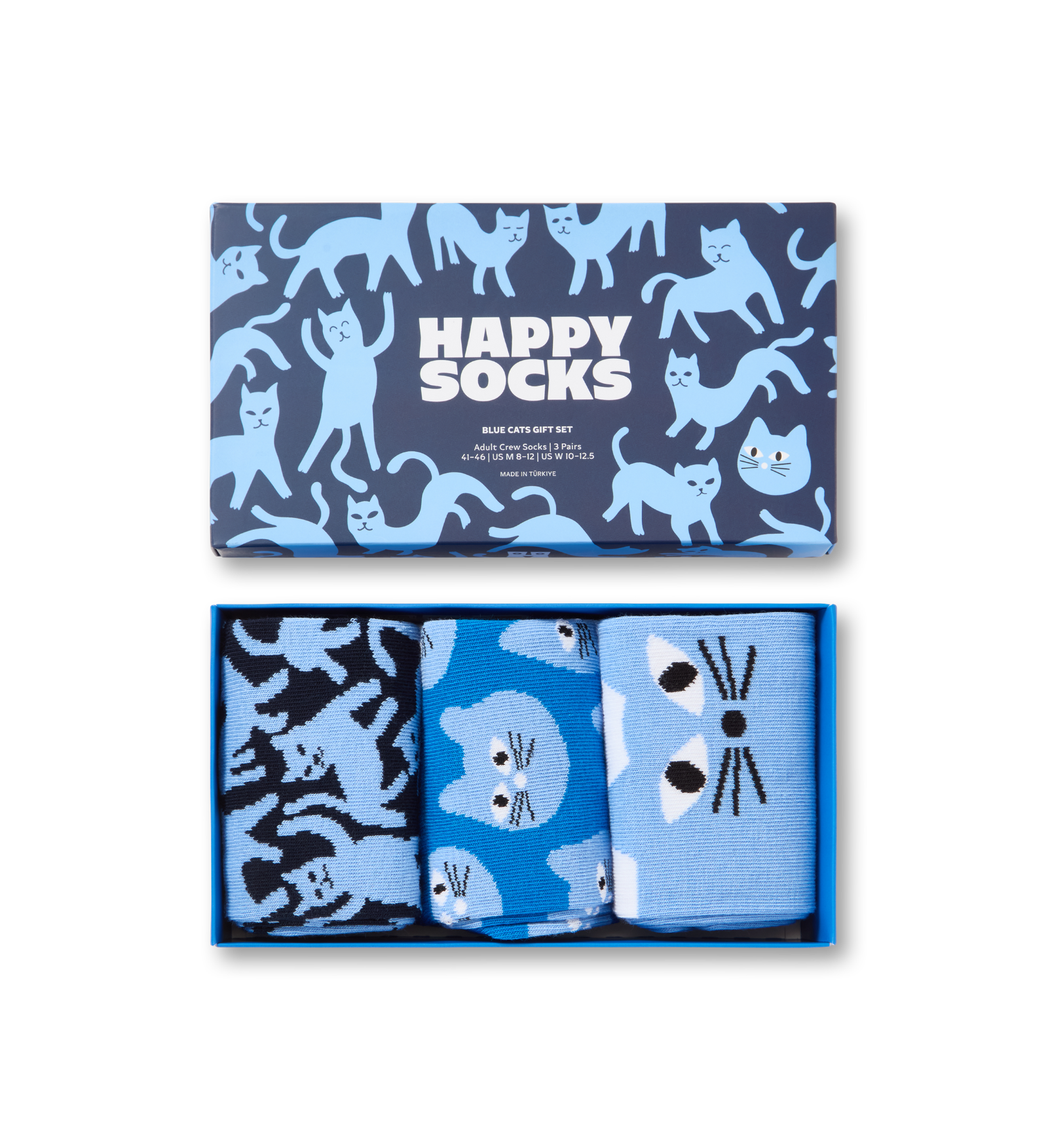 A boxed gift set of three pairs of socks with a blue and navy cat pattern. The top lid shows the brand 'Happy Socks' and the three pairs inside feature different cat-face and cat-pattern designs in shades of blue, navy, and black.