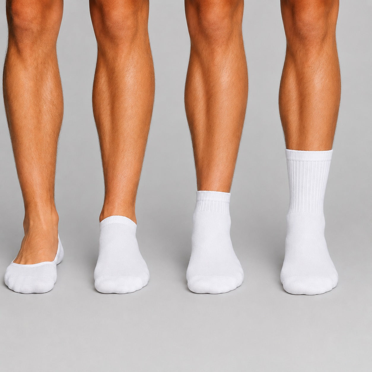 Close-up of legs wearing white socks against a gray background
