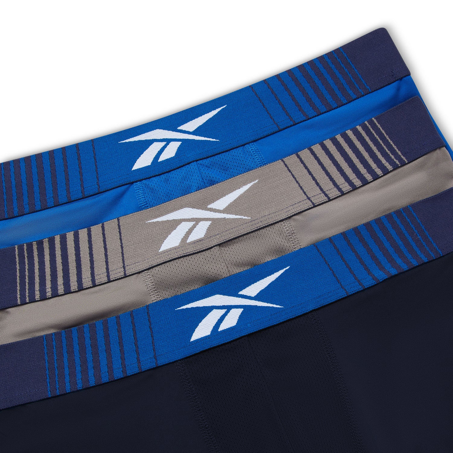 Three Reebok headbands in blue, gray, and black on a white background