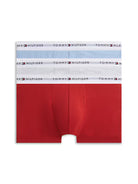 A pair of Tommy Hilfiger men's boxer briefs featuring a distinctive color-blocked design with a solid red lower half and white and light blue upper panels, each with a white waistband printed with the Tommy Hilfiger logo.