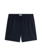 Navy blue drawstring shorts with a small Tommy Hilfiger flag logo on the lower left hem, displayed flat against a white background.