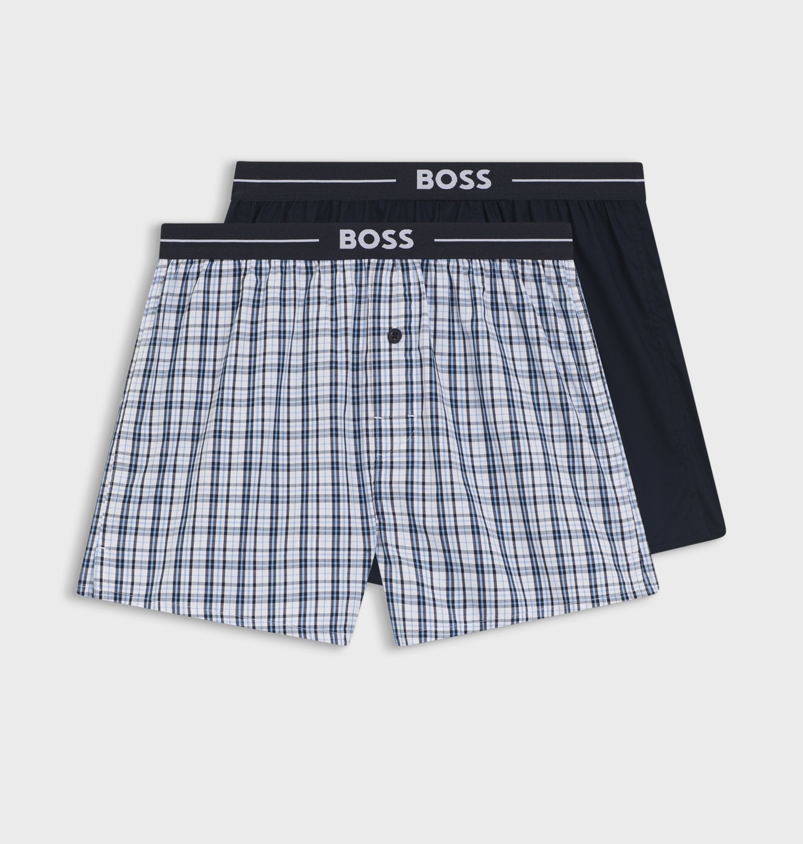 Two pairs of boxer shorts with a checkered pattern and black waistband on a white background, branded 'BOSS'.