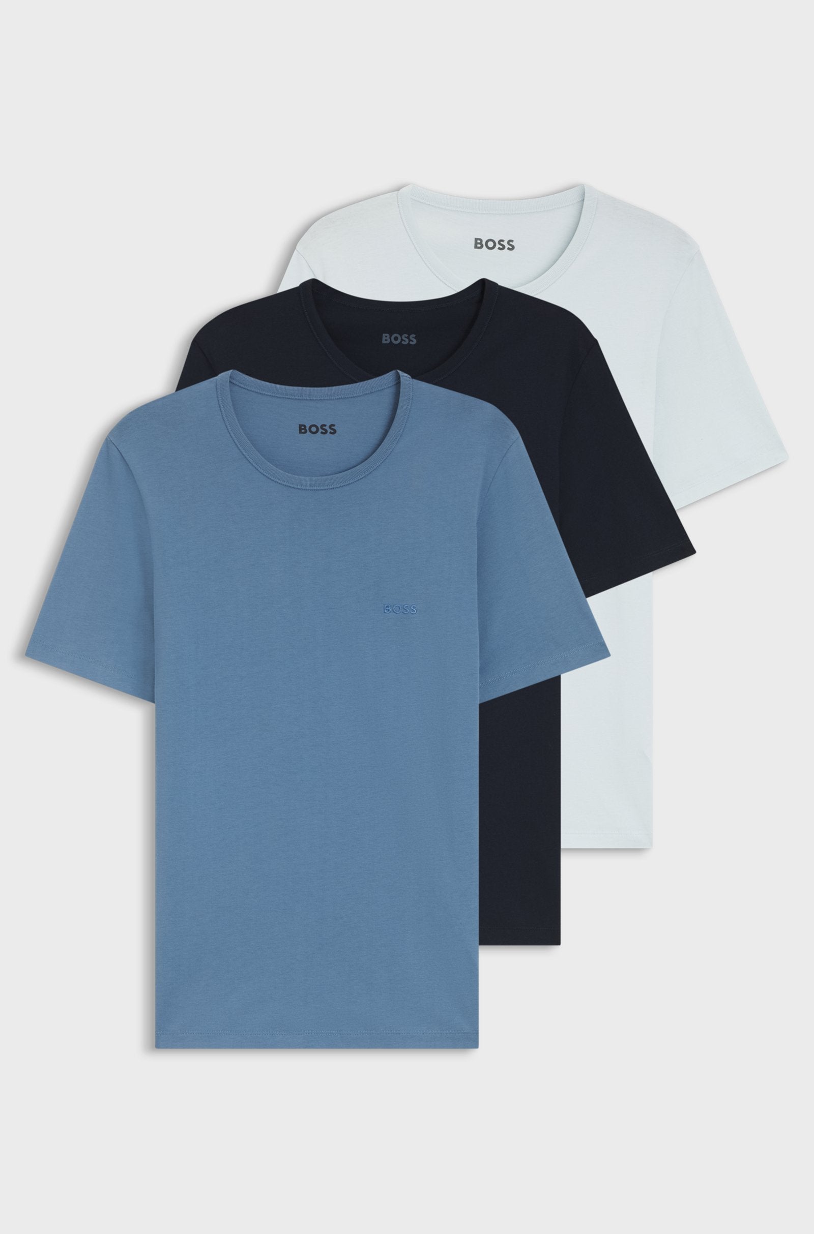 Three short-sleeve crewneck t-shirts stacked together, showing light blue, black, and white color options against a plain white background.